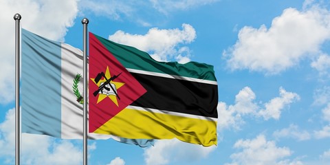 Guatemala and Mozambique flag waving in the wind against white cloudy blue sky together. Diplomacy concept, international relations.