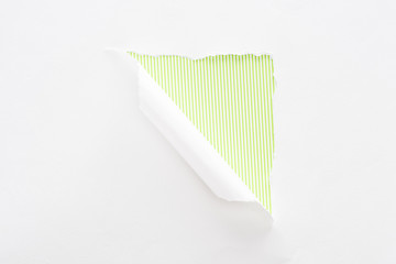 white torn and rolled paper on colorful lime green striped background