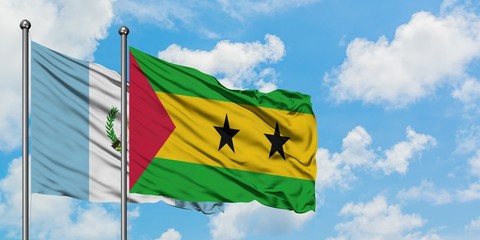 Guatemala and Sao Tome And Principe flag waving in the wind against white cloudy blue sky together....