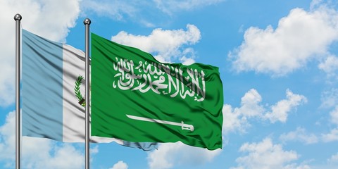 Guatemala and Saudi Arabia flag waving in the wind against white cloudy blue sky together. Diplomacy concept, international relations.