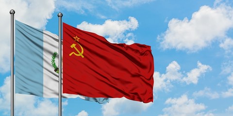 Guatemala and Soviet Union flag waving in the wind against white cloudy blue sky together. Diplomacy concept, international relations.
