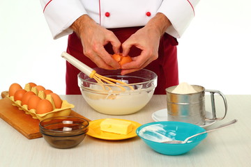 Cracking egg and adding into bowl. Making bundt cake with chocolate glaze.