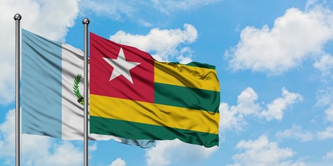 Guatemala and Togo flag waving in the wind against white cloudy blue sky together. Diplomacy concept, international relations.