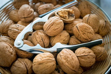 Nutcracker on brown walnuts. Whole walnuts