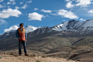 Fototapeta na wymiar Traveler man enjoy at Tso Moriri Lake , Background is Snow top mountain, Jammu and Kashmir, India