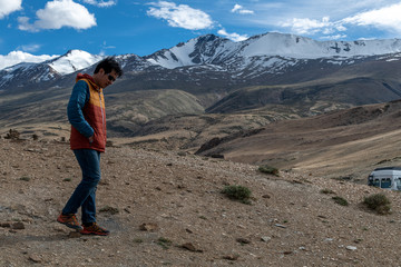 Traveler man enjoy at Tso Moriri Lake , Background is Snow top mountain,  Jammu and Kashmir, India