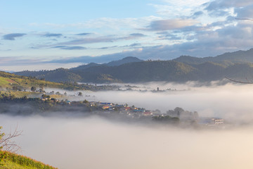 View of village covered in foggy during morning sunrise.