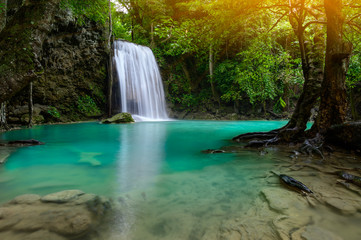 Fototapeta na wymiar A beautiful waterfall deep in the tropical forest steep mountain adventure in the rainforest.