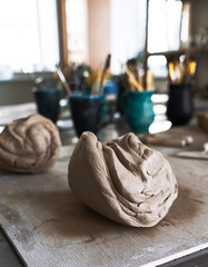 A large piece of mashed clay on the table in the workshop.