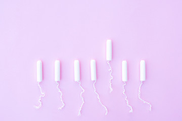 Female tampons for menstruation on a pink background.