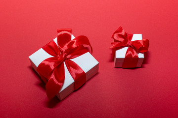 Two boxes with red ribbon and bow isolated on red. Boxing day . 