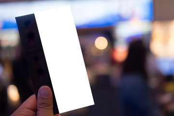 Hand holding three cinema tickets