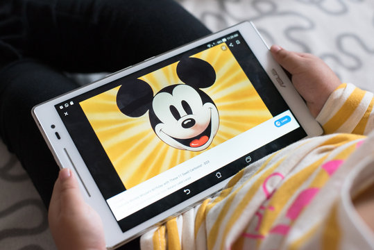 Petaling Jaya,Selangor,Malaysia - 03 November 2019 : Litlle girl watching mickey mouse educational program video on youtube using digital tablet. Mickey Mouse is a famous cartoon character from Disney
