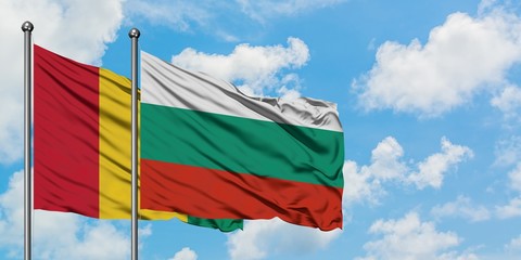 Guinea and Bulgaria flag waving in the wind against white cloudy blue sky together. Diplomacy concept, international relations.