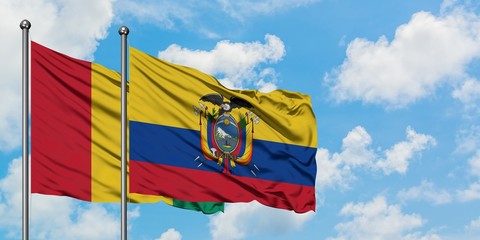 Guinea and Ecuador flag waving in the wind against white cloudy blue sky together. Diplomacy concept, international relations.