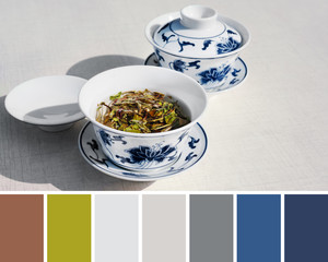 Trendy color matching palette from close-up on two cups of traditional white chinese tea with white peony on white table