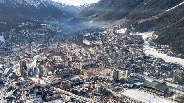 Aerial drone view of snow covered Chamonix city in the afternoon