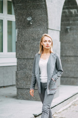 Business style, the situation in the bright office and outside. Business portrait of a beautiful girl on the street.