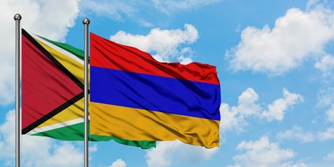 Guyana and Armenia flag waving in the wind against white cloudy blue sky together. Diplomacy concept, international relations.