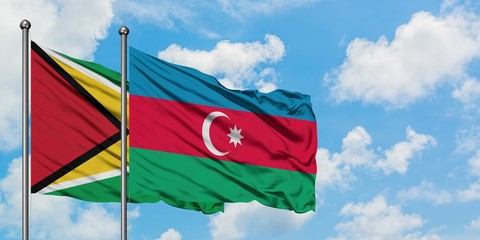 Guyana and Azerbaijan flag waving in the wind against white cloudy blue sky together. Diplomacy concept, international relations.