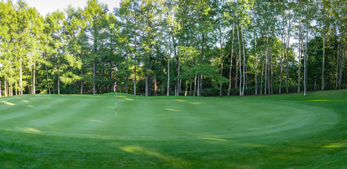 Panorama View of Golf Course with beautiful putting green. Golf course with a rich green turf beautiful scenery.