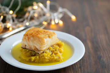 cod fish with sweet potato and olive oil on white dish