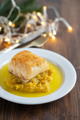 cod fish with sweet potato and olive oil on white dish