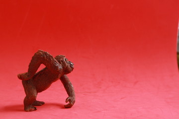 orangutan shaped plastic toy in color background