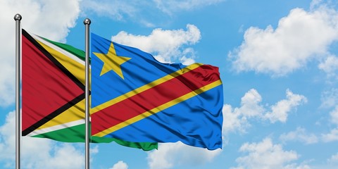 Guyana and Congo flag waving in the wind against white cloudy blue sky together. Diplomacy concept, international relations.