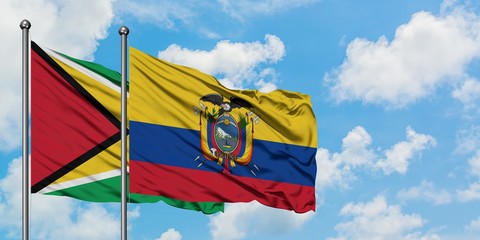 Guyana and Ecuador flag waving in the wind against white cloudy blue sky together. Diplomacy concept, international relations.
