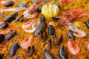 Sea food with rice and lemon mix dish with shrimps and mussels (paella)