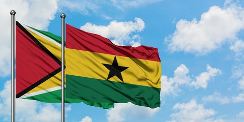Guyana and Ghana flag waving in the wind against white cloudy blue sky together. Diplomacy concept, international relations.