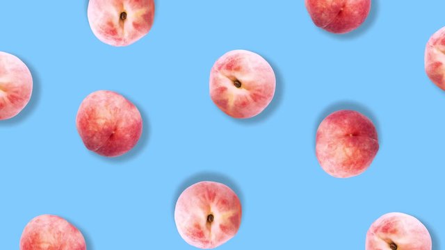 Colorful fruit pattern of peaches on blue background. Top view. Flat lay. Rotation peaches.