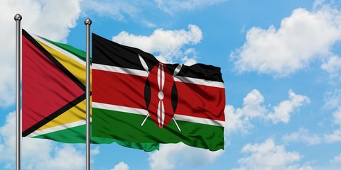 Guyana and Kenya flag waving in the wind against white cloudy blue sky together. Diplomacy concept, international relations.