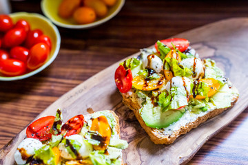 Toasts with Cherry Tomatoes, Mozzarella Cheese, Basil Leaves and Balsamic Sauce