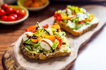 Toasts with Cherry Tomatoes, Mozzarella Cheese, Basil Leaves and Balsamic Sauce