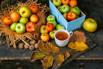 Ripe green and red apples on a wooden table. Still life of autumn fruits