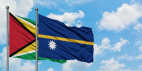 Guyana and Nauru flag waving in the wind against white cloudy blue sky together. Diplomacy concept, international relations.
