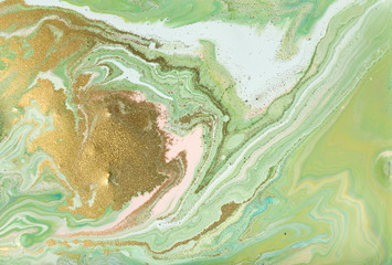 Pink and green marble pattern. Abstract liquid background with golden powder.