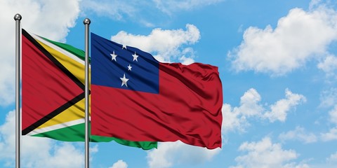 Guyana and Samoa flag waving in the wind against white cloudy blue sky together. Diplomacy concept,...