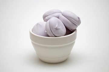 Sweet tasty marshmallows in a plate on a white background.