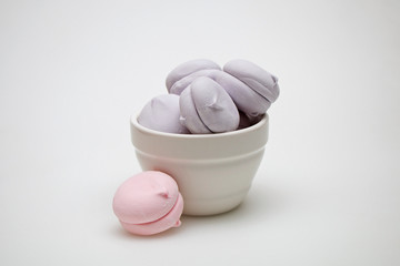 Sweet tasty marshmallows in a plate on a white background.