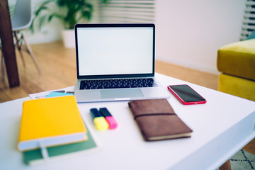 Naklejka premium Workspace with laptop and stationery at home