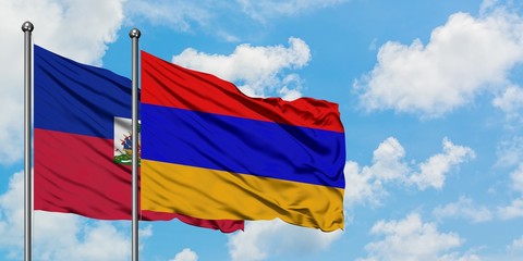 Haiti and Armenia flag waving in the wind against white cloudy blue sky together. Diplomacy concept, international relations.