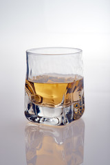 Whiskey glass on a white background with relejo. Isolated shot