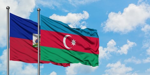 Haiti and Azerbaijan flag waving in the wind against white cloudy blue sky together. Diplomacy...