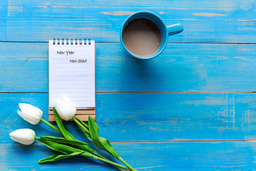 New Year and New Start 2020 Conceptual. Cup coffee hot steaming  warm scarf with paper note for...