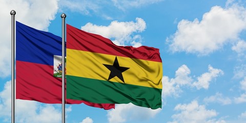 Haiti and Ghana flag waving in the wind against white cloudy blue sky together. Diplomacy concept, international relations.