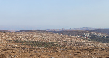 View from the highway number 5 to Jordan mountains and the Palestinian village Mukhamas located on a hill in Samaria region in Benjamin district, Israel - obrazy, fototapety, plakaty