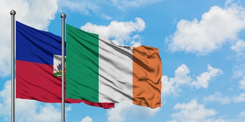 Haiti and Ireland flag waving in the wind against white cloudy blue sky together. Diplomacy concept, international relations.